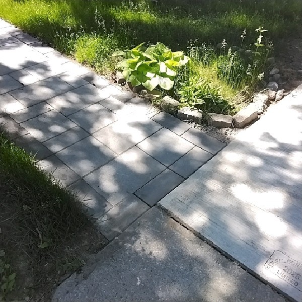 Stone paver walkway with garden bed