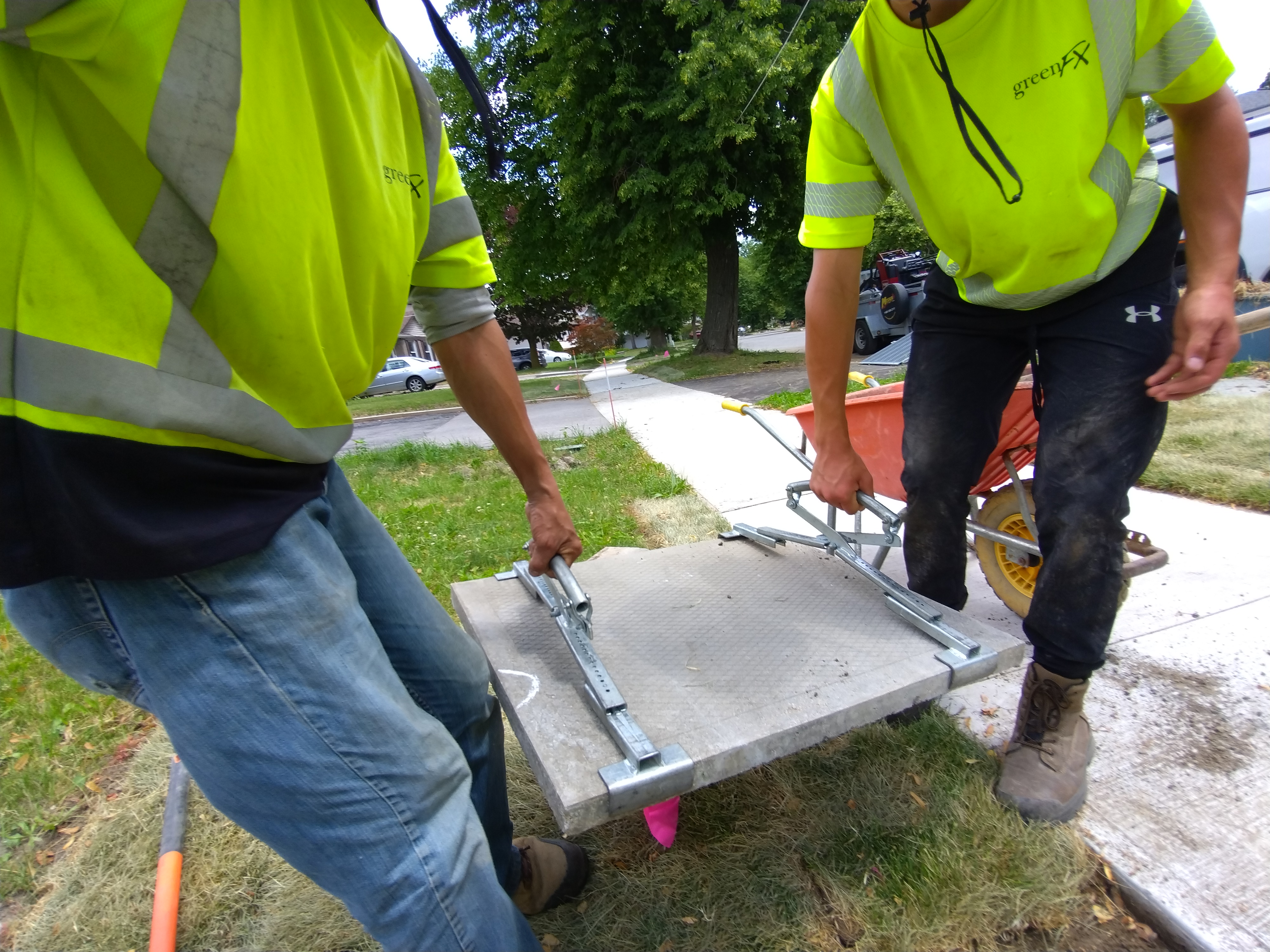 Team installing large paver slabs